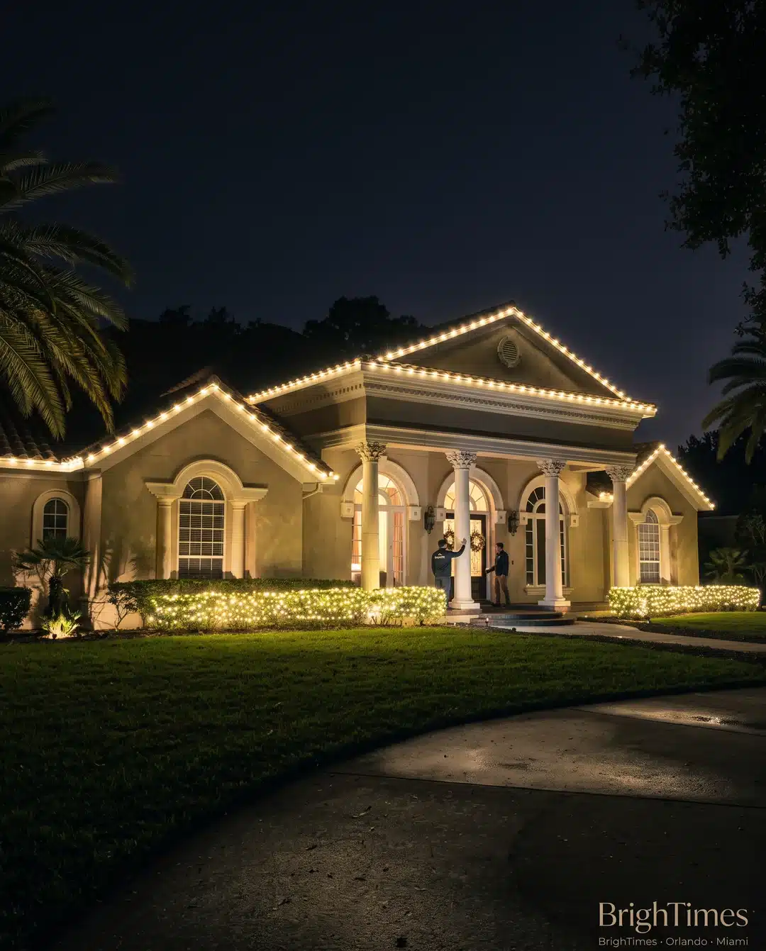 Home at night with warm white Christmas lights outlining the roofline